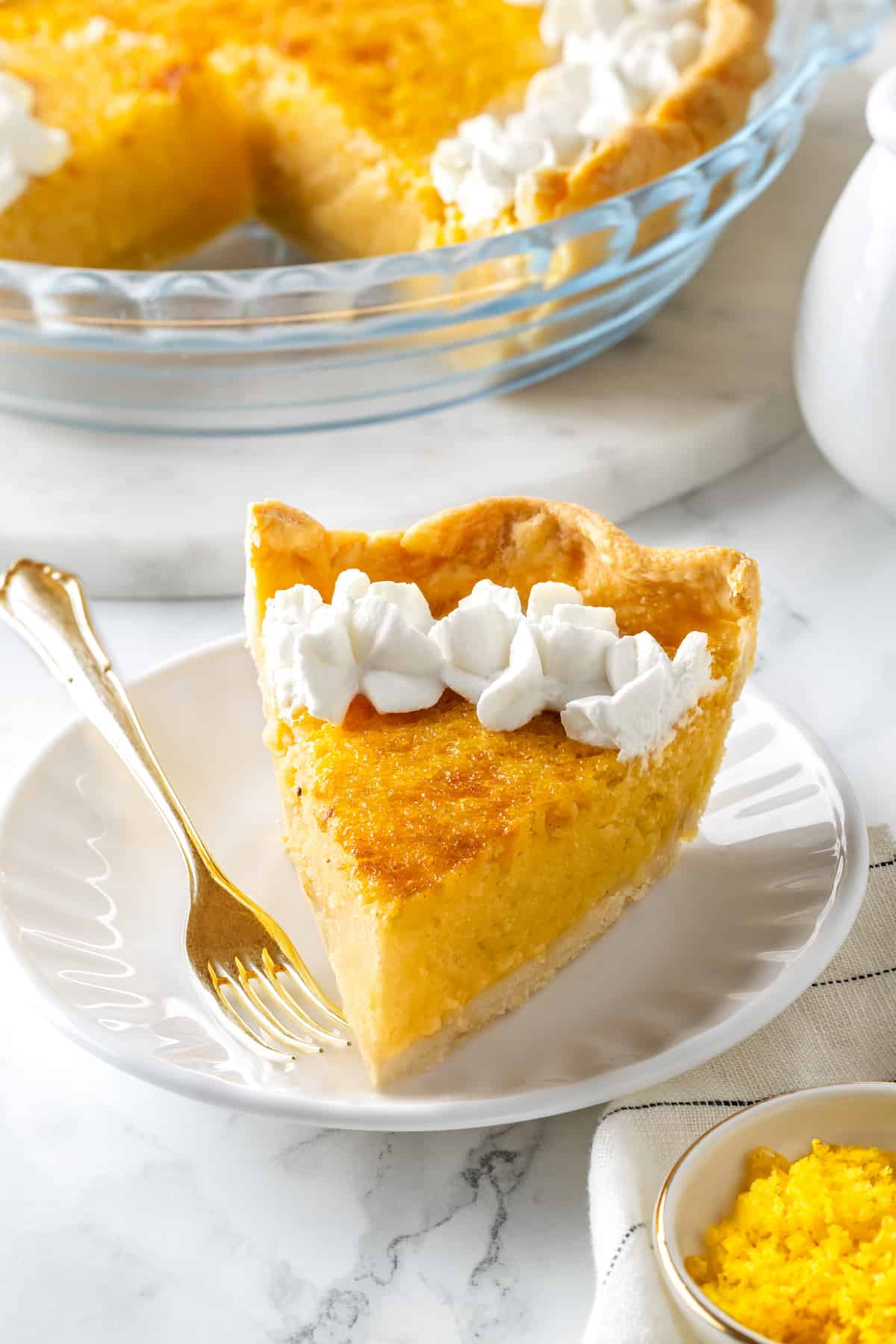 Slice of buttermilk pie on plate with fork