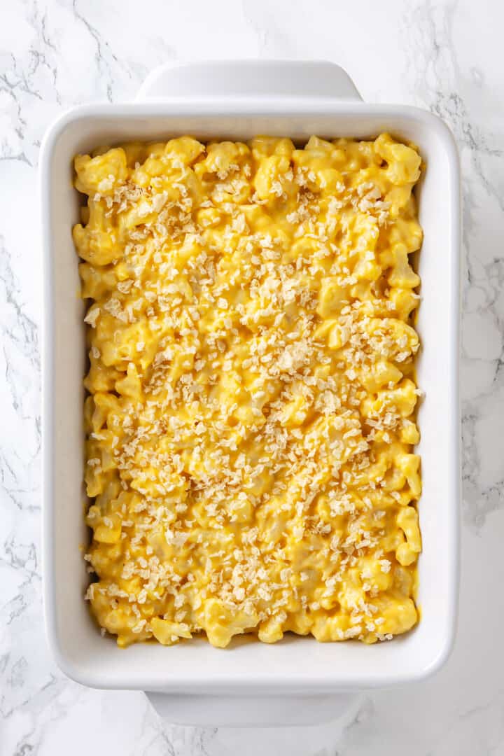 Overhead view of cauliflower mac and cheese in baking dish with panko on top
