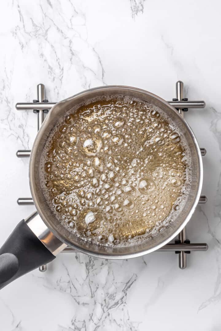 Overhead view of sugar syrup in saucepan