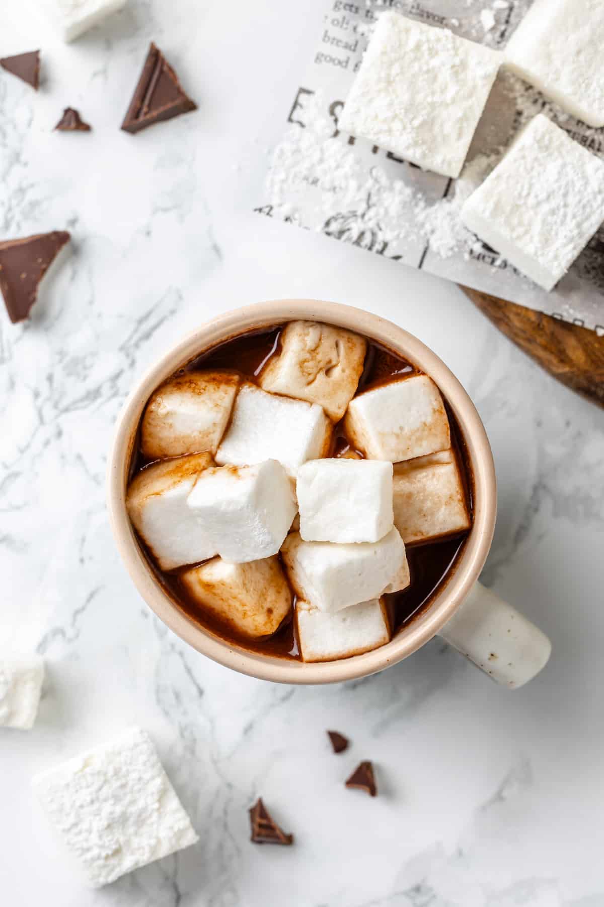Overhead view of hot chocolate in mug with vegan marshmallows
