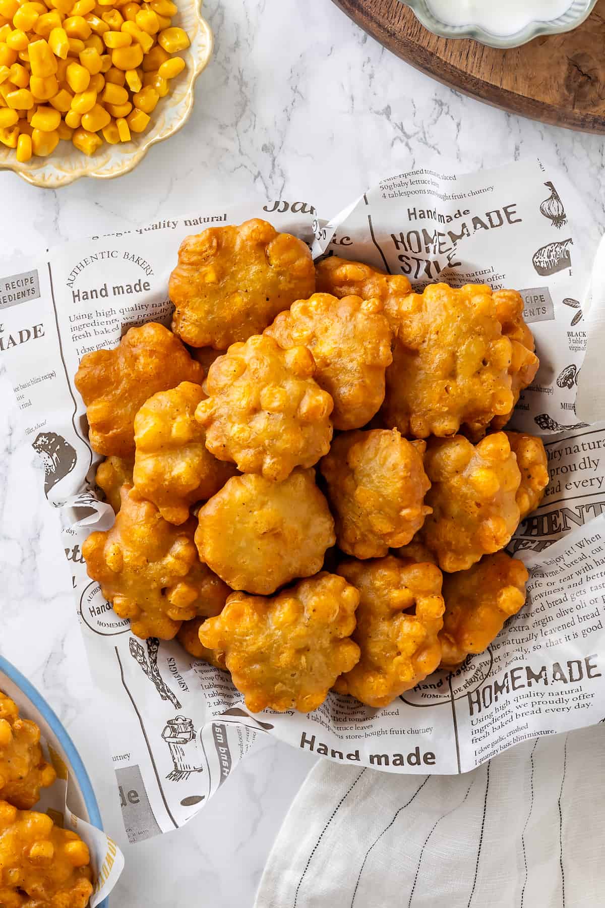 Overhead view of crispy fried corn nuggets in basket