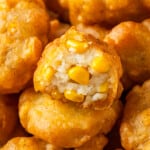 Pile of corn nuggets, with one bitten to show corn kernels inside