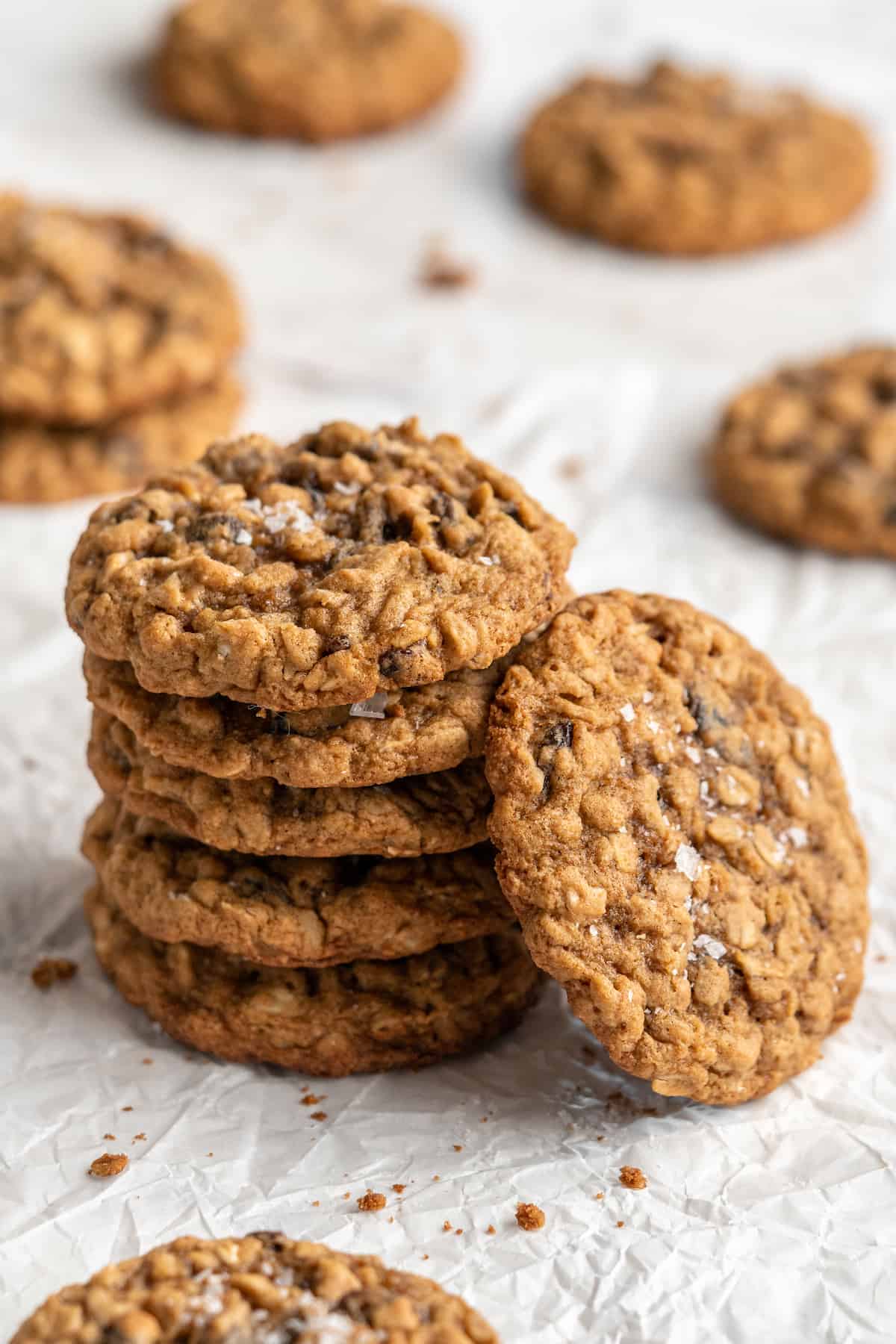 Stack of vegan oatmeal cookies with one cookie leaning against stack