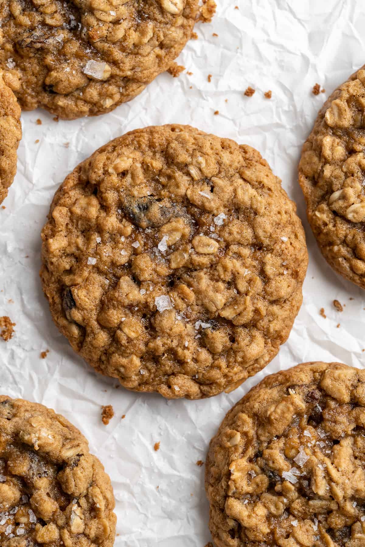 Overhead view of vegan oatmeal raisin cookies on parchment paper