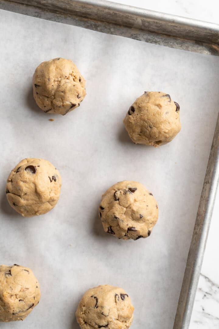 Overhead view of balls of cookie dough on baking sheet