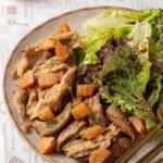 Vegan chicken on plate with salad and roasted carrots