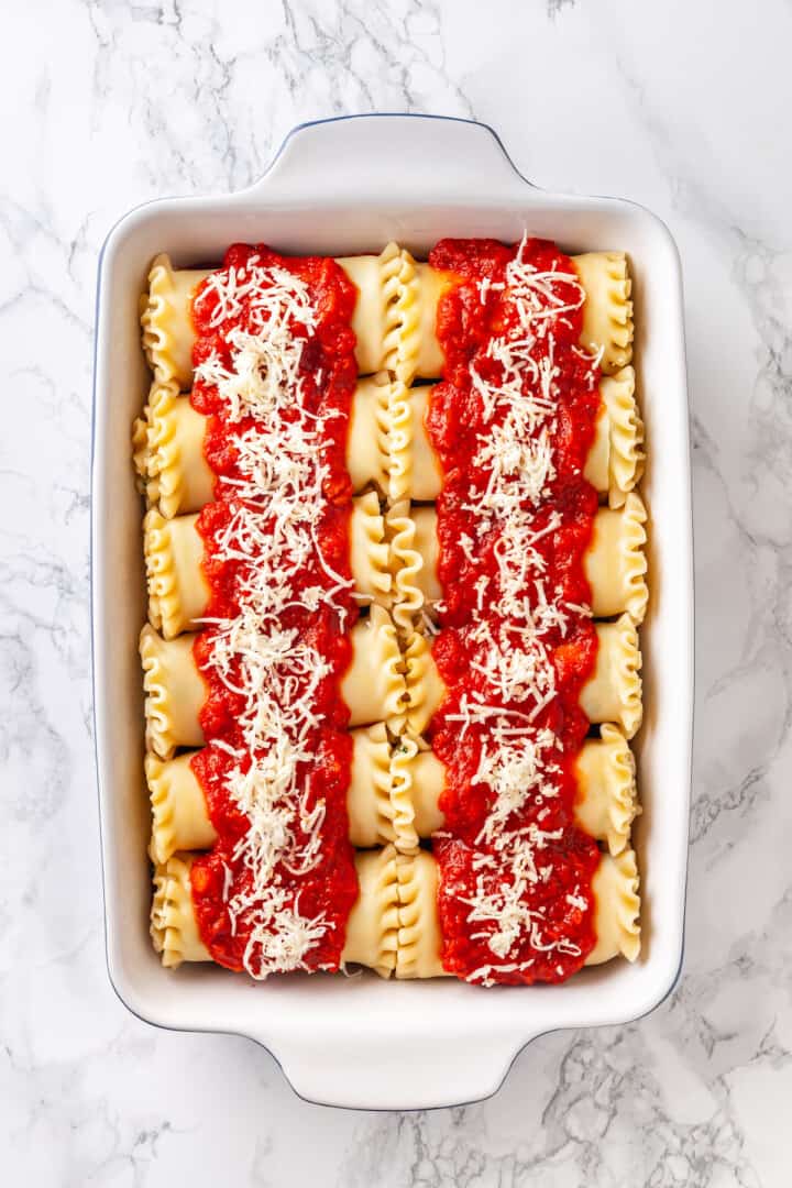 Overhead view of vegan lasagna rolls in baking dish before baking