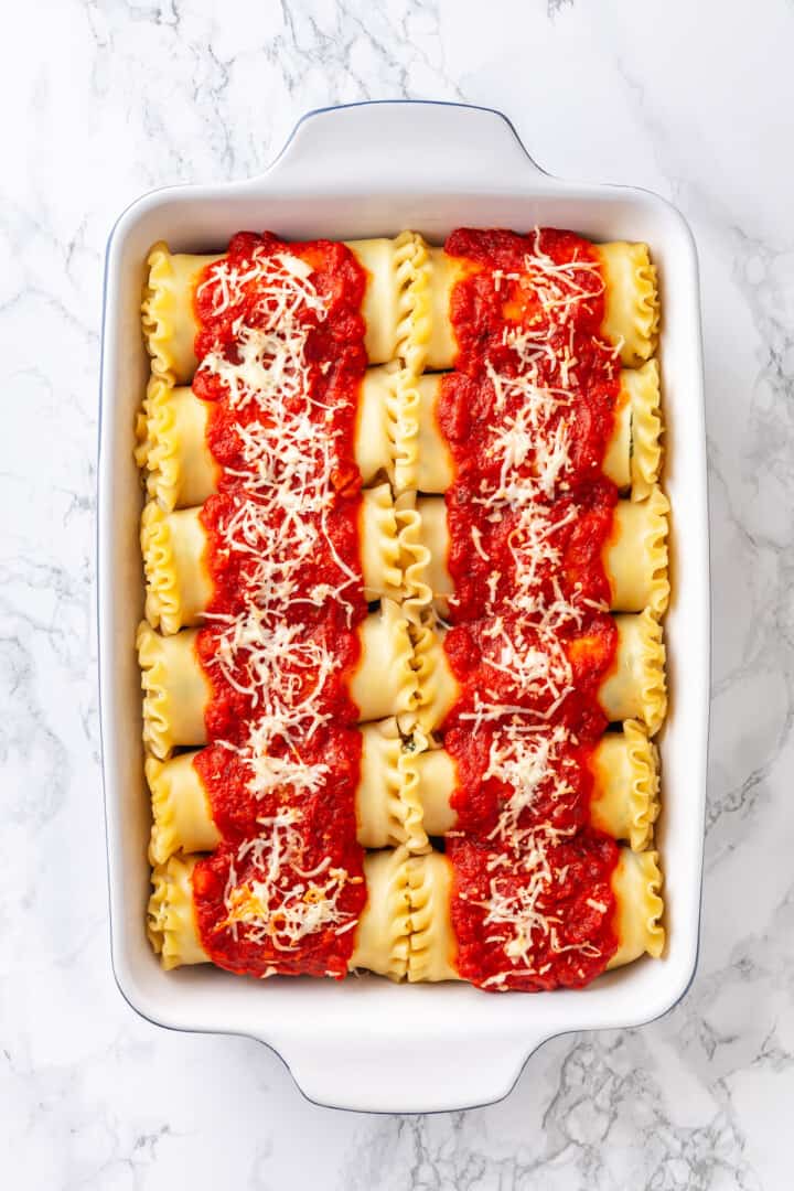 Overhead view of vegan spinach ricotta lasagna rolls in casserole dish