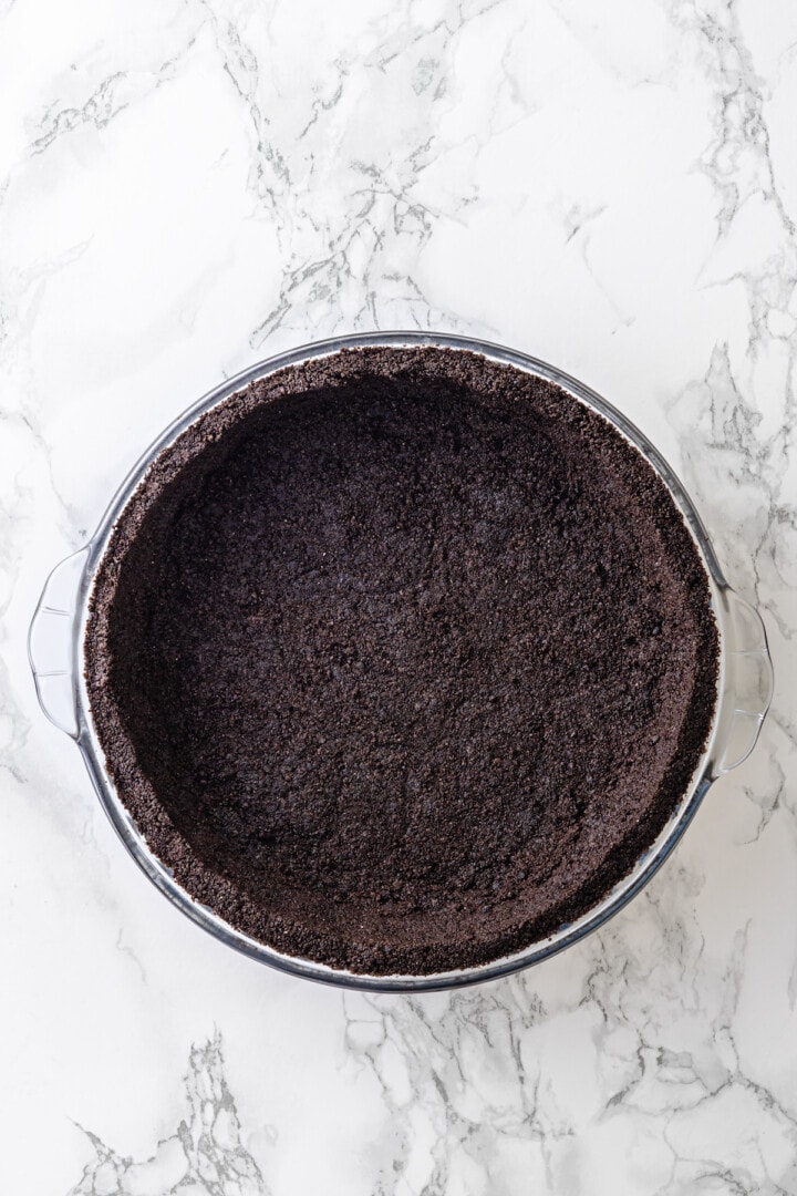 Overhead view of Oreo crust in glass pie dish