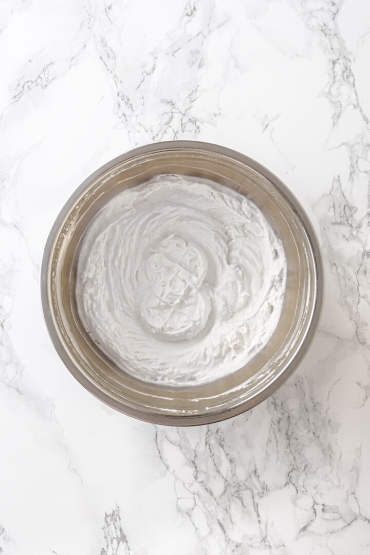 Overhead view of coconut whipped cream in mixing bowl