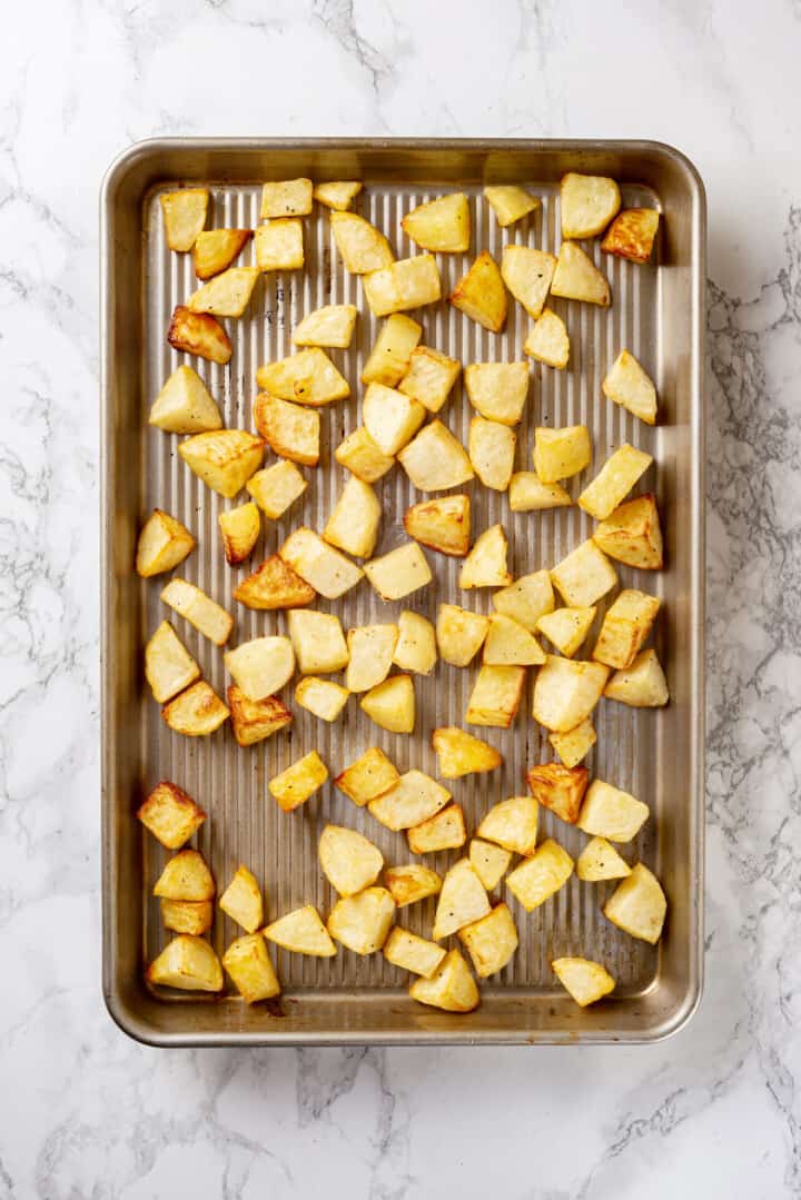 Overhead view of roasted potatoes on baking sheet