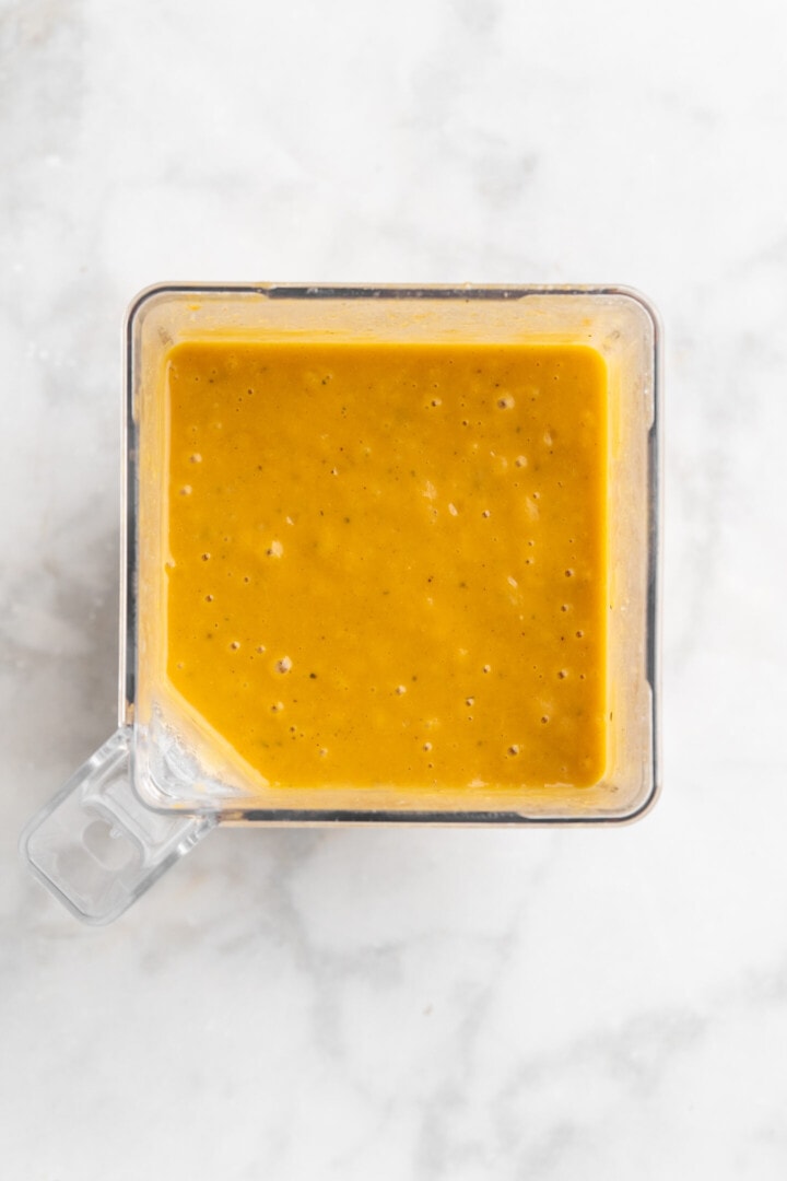 Overhead view of pureed butternut squash soup in blender