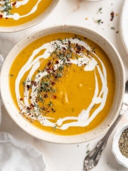 Overhead view of creamy butternut squash soup in rustic bowl