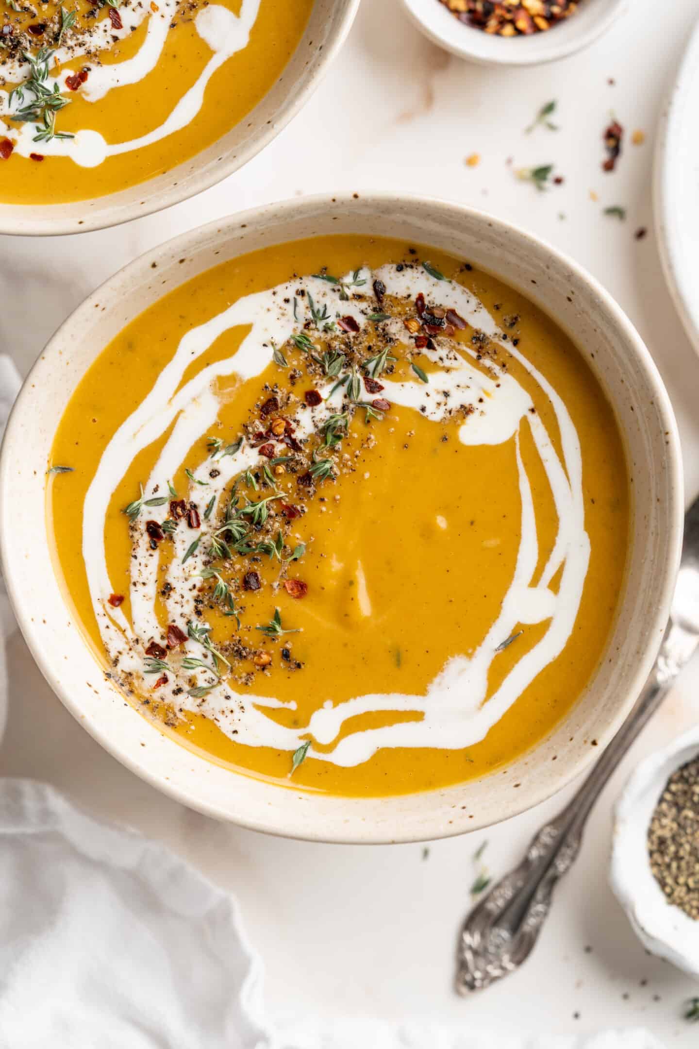 Overhead view of creamy butternut squash soup in rustic bowl