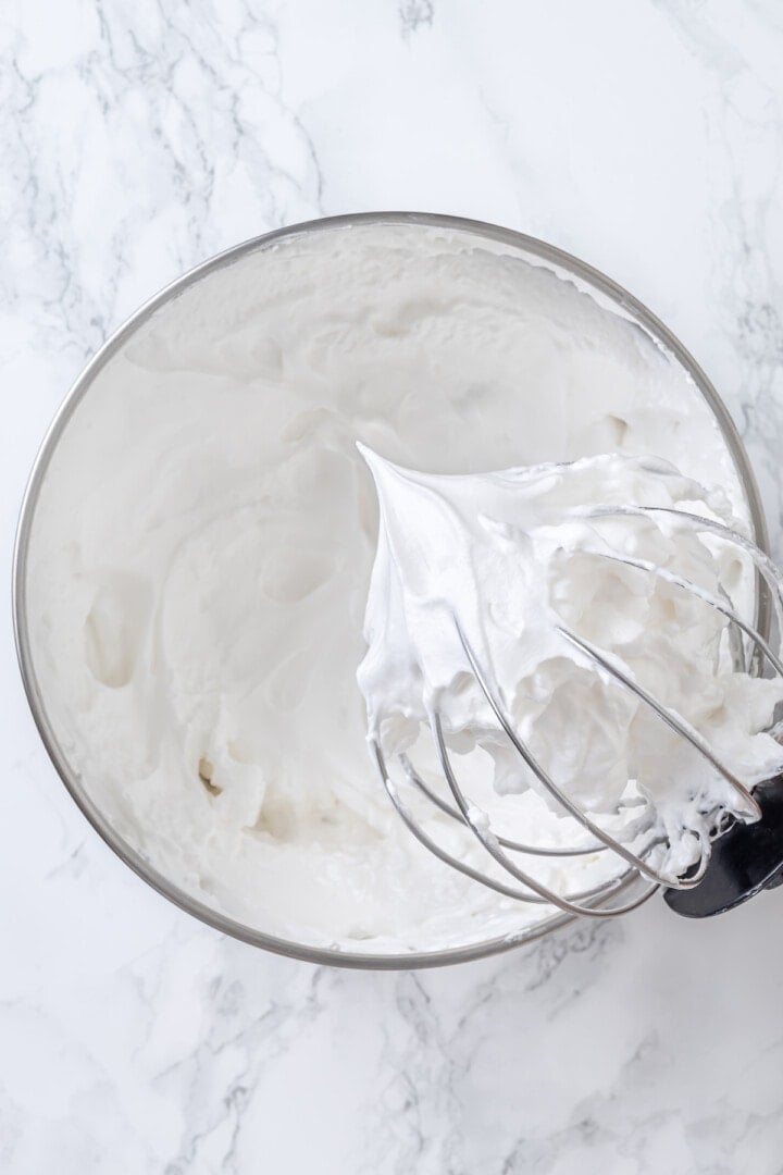 Whipped aquafaba in mixer bowl with whisk attachment