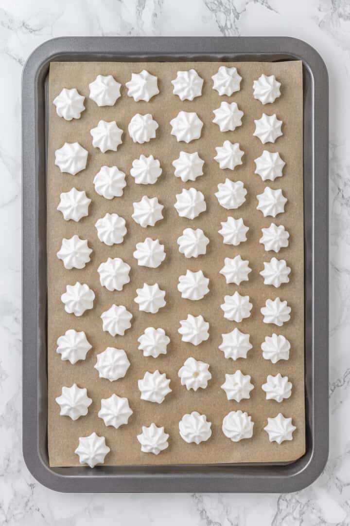 Vegan meringues on parchment lined baking sheet