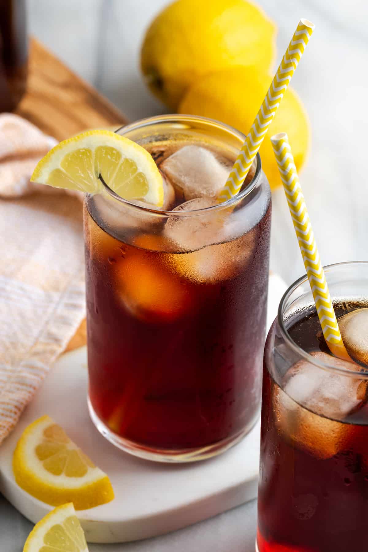 Glass of Southern sweet tea filled with ice cubes and finished with lemon wedge