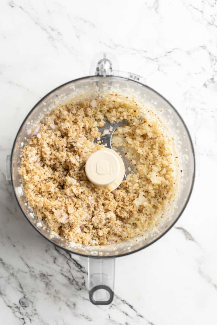 Overhead view of riced cauliflower in food processor with quinoa