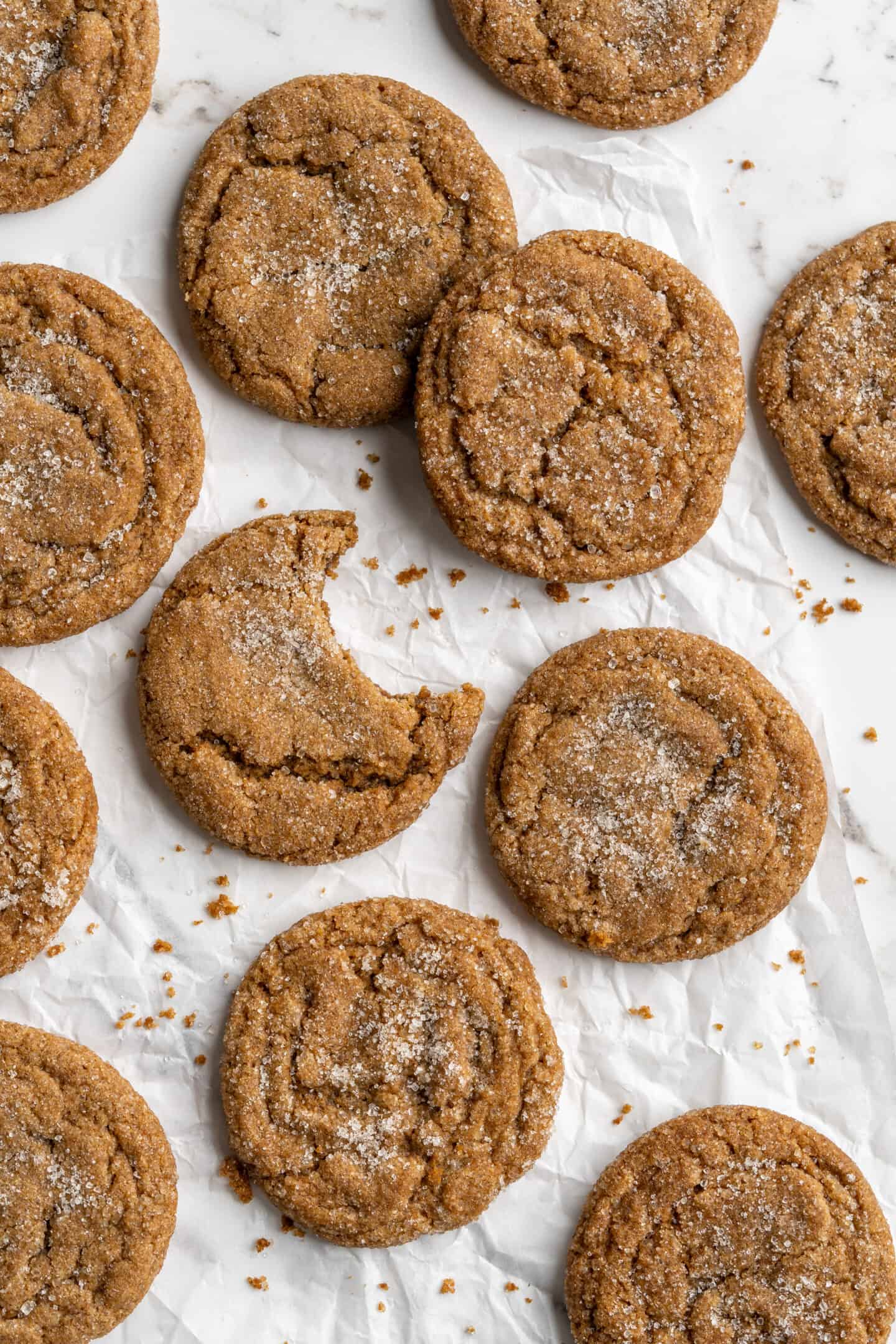 Overhead view of gingersnap molasses cookies on crumpled parchment