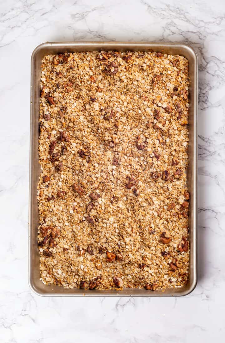 Overhead view of granola butter ingredients toasted on sheet pan