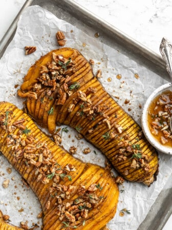 Overhead view of hasselback butternut squash on parchment-lined sheet pan