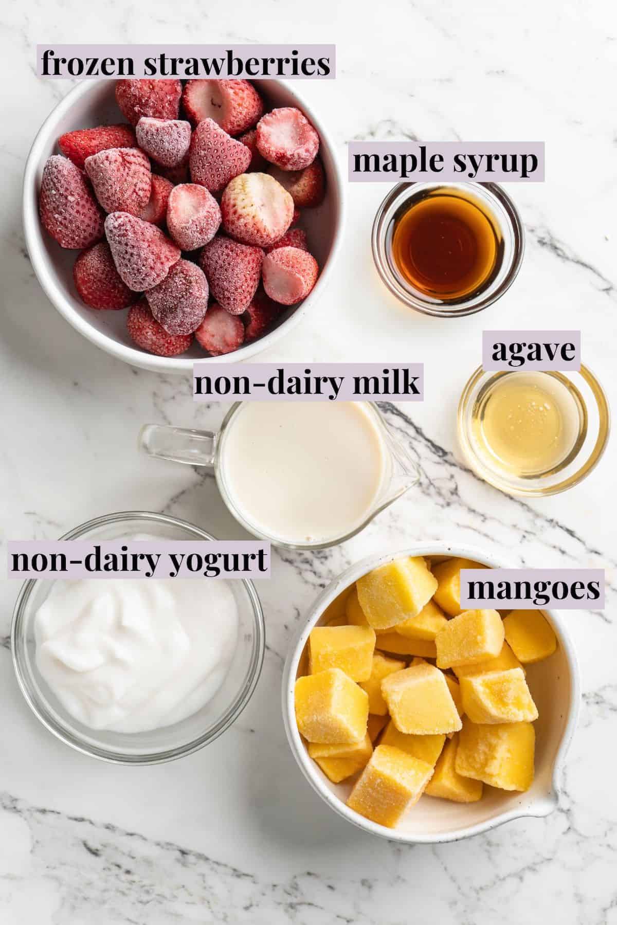 Overhead view of ingredients for strawberry mango smoothie with labels