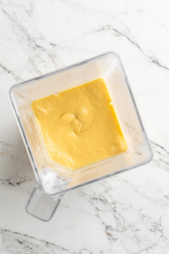 Overhead view of mango smoothie in blender