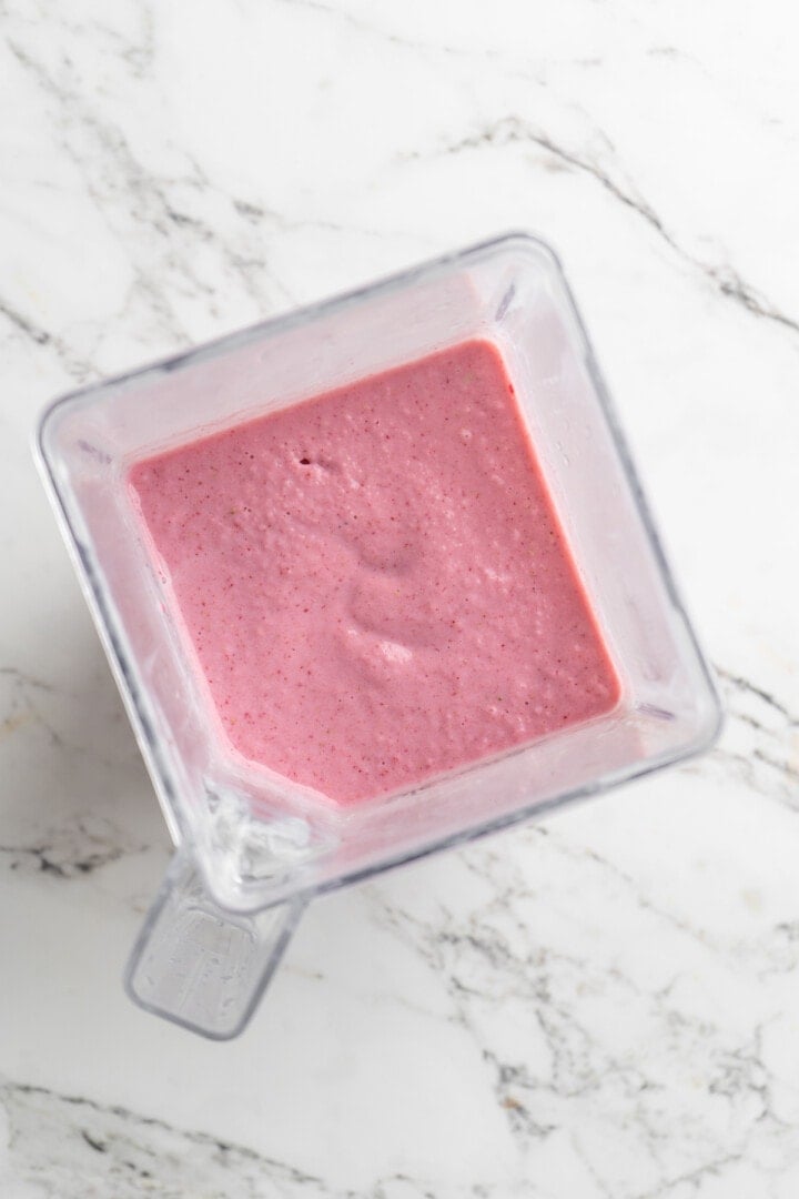 Overhead view of strawberry smoothie in blender