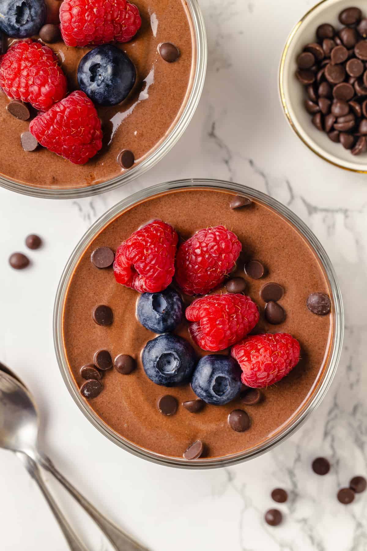 Overhead view of rich chocolate protein pudding in 2 glass bowls