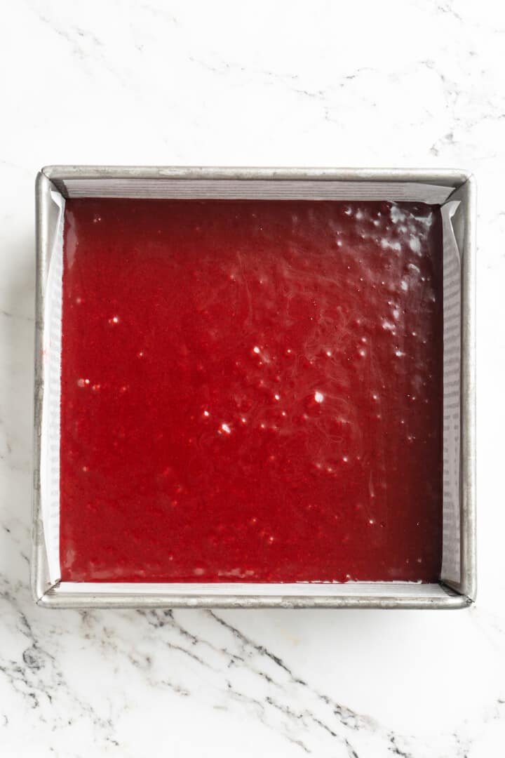 Overhead view of red velvet brownie batter in pan