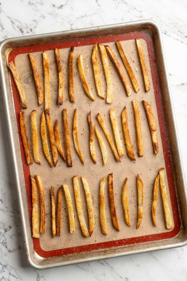 Overhead view of homemade fries on sheet pan