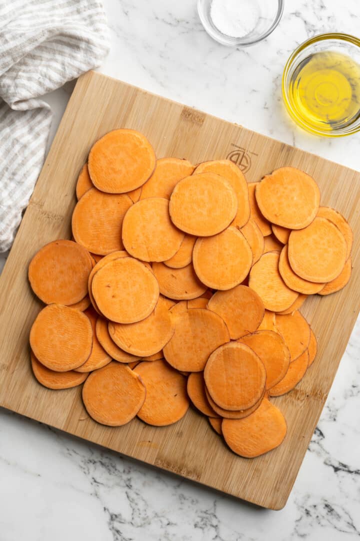 Overhead view of sweet potato slices on cutting board