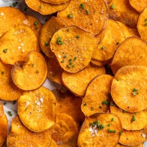 Pile of crispy homemade sweet potato chips with sea salt
