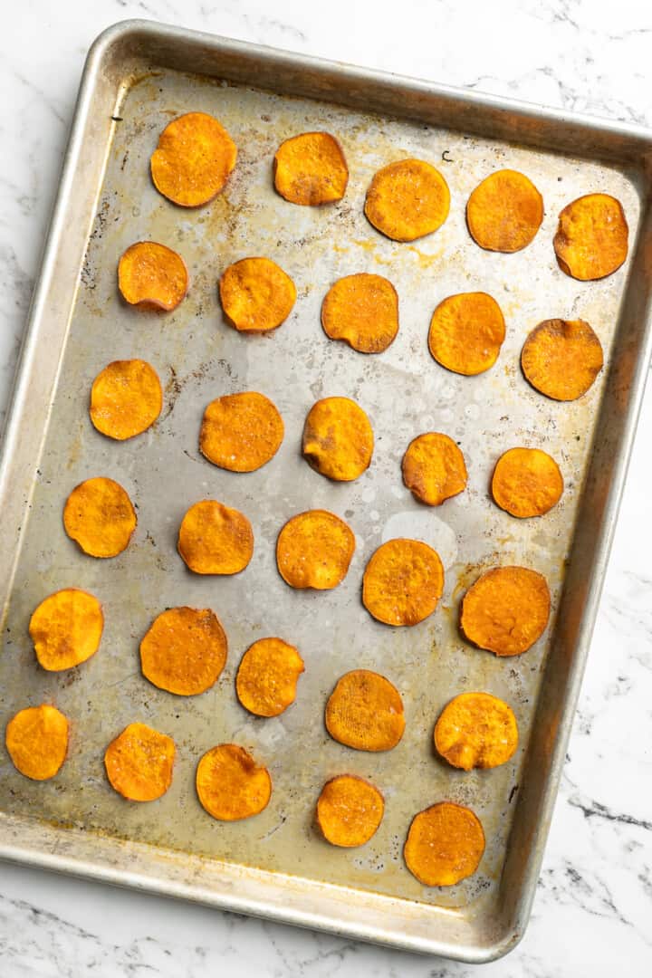Overhead view of sweet potato chips on baking sheet