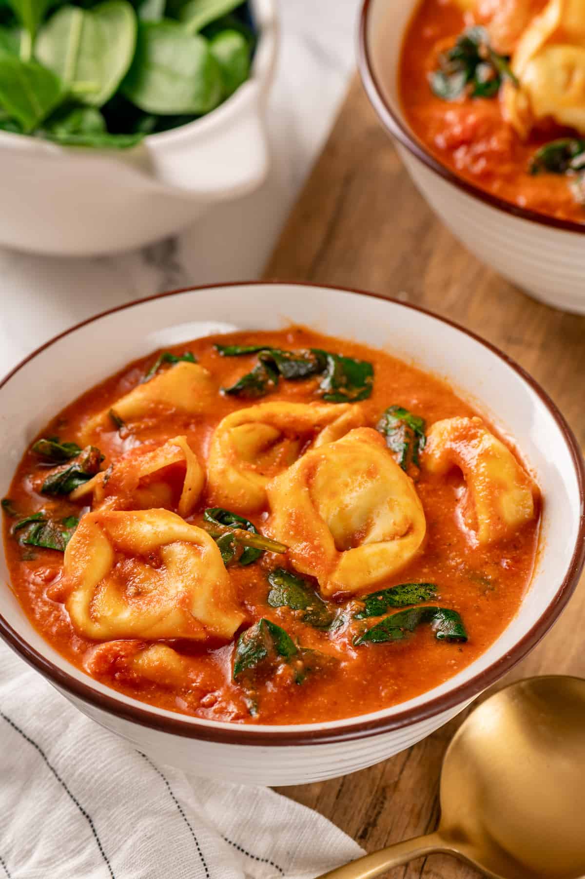 Vegan tomato tortellini soup in bowls