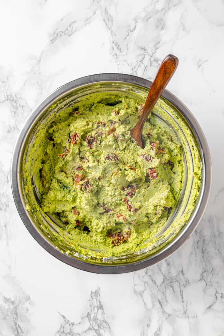 Overhead view of pesto cream cheese mixture in bowl