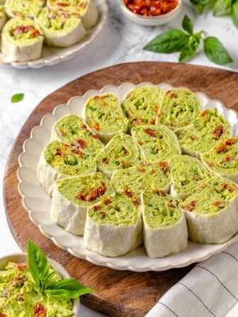 Plate of pesto pinwheel sandwiches with sun-dried tomatoes