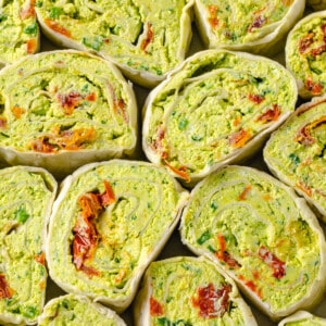 Overhead view of tortilla roll-ups tightly packed together
