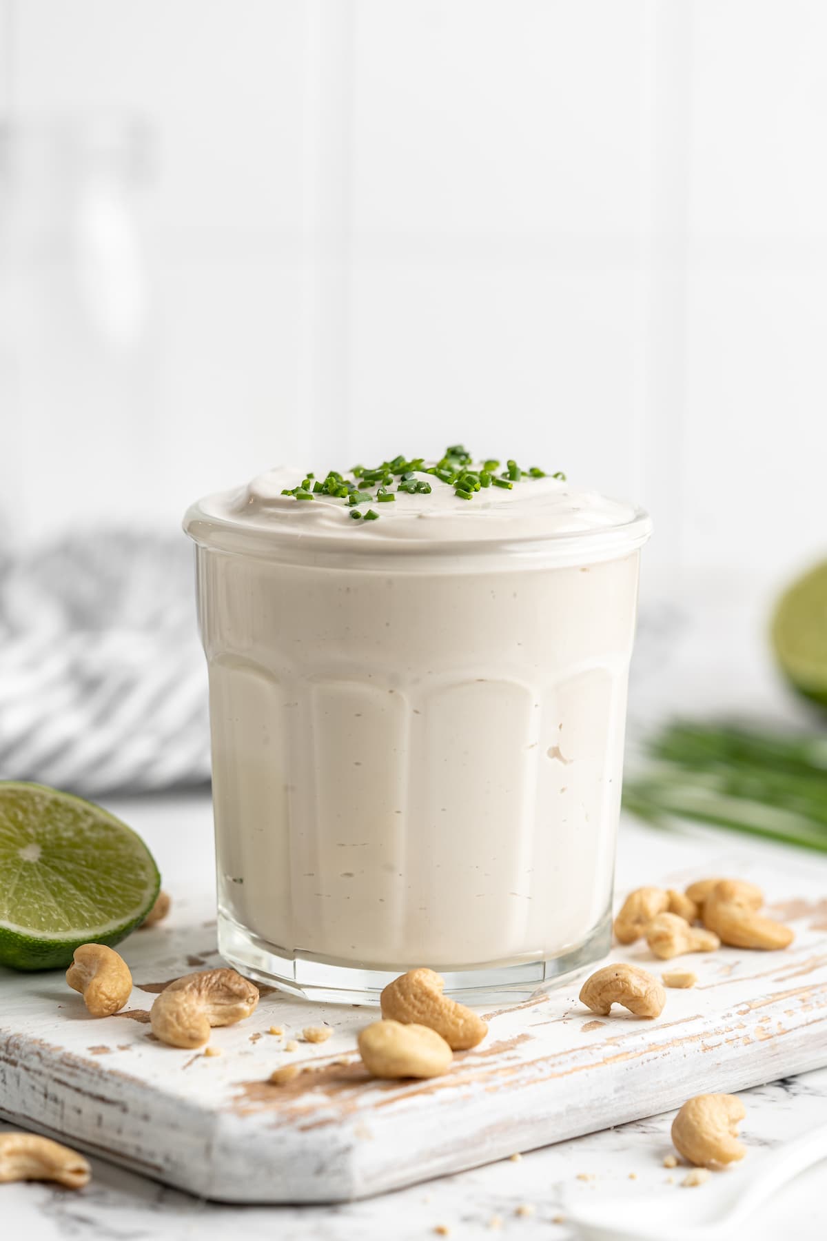 Vegan sour cream in jar with chives on top