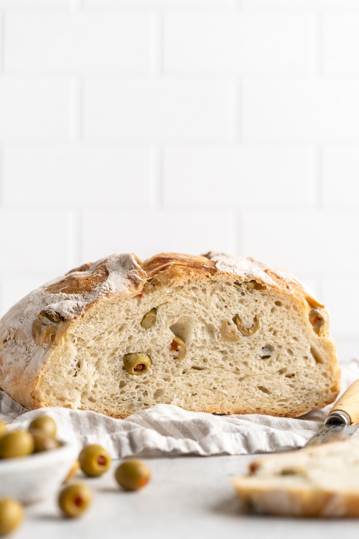 Cut olive bread loaf, showing interior