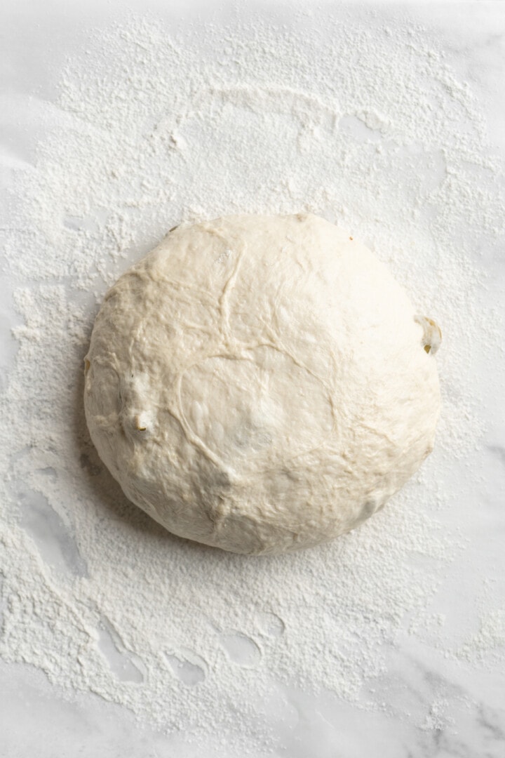 Overhead view of shaped dough for olive bread