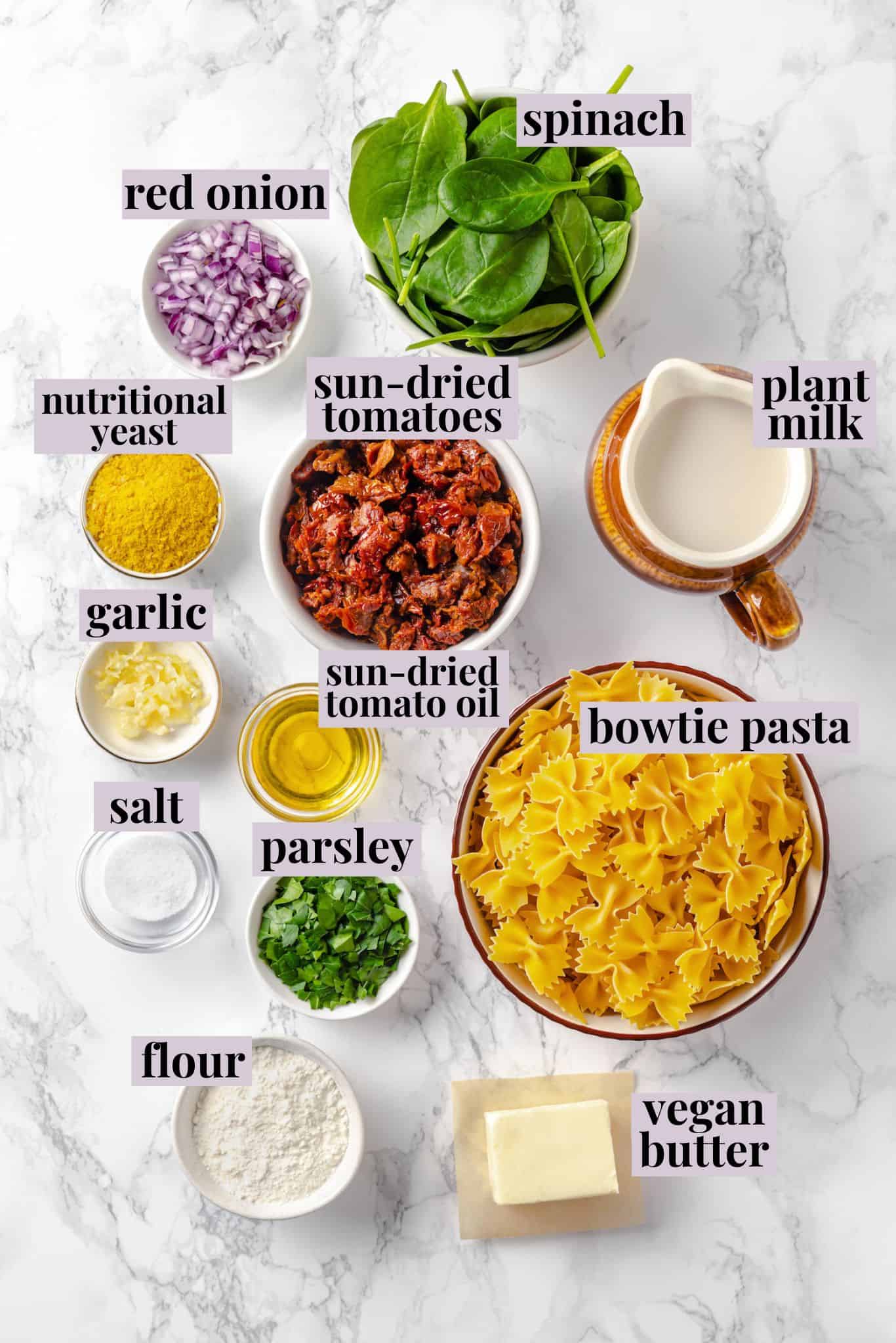 Overhead view of ingredients for sun-dried tomato pasta with labels