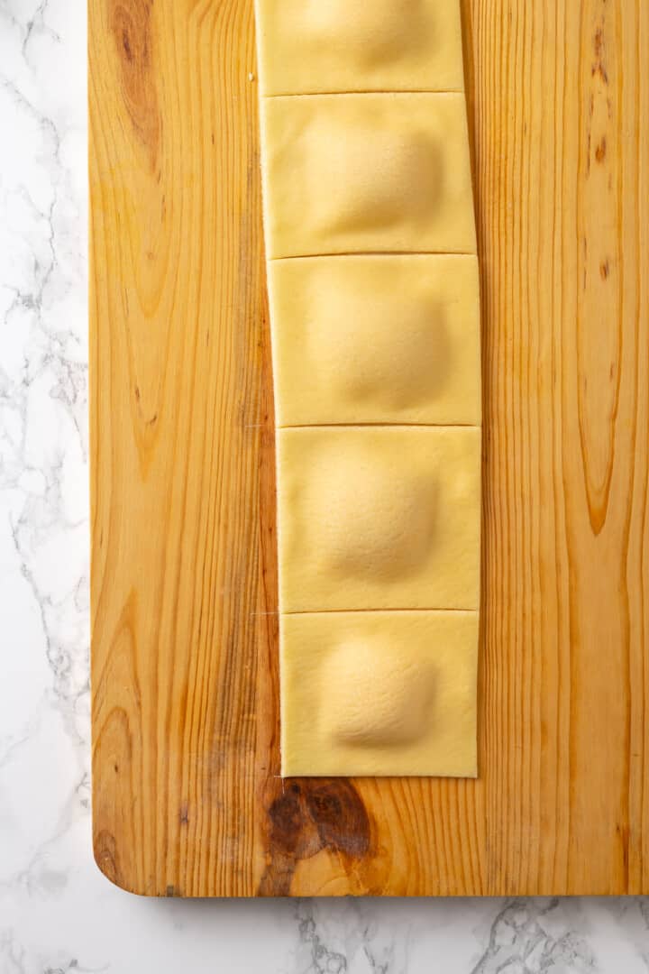 Cut ravioli on wooden board
