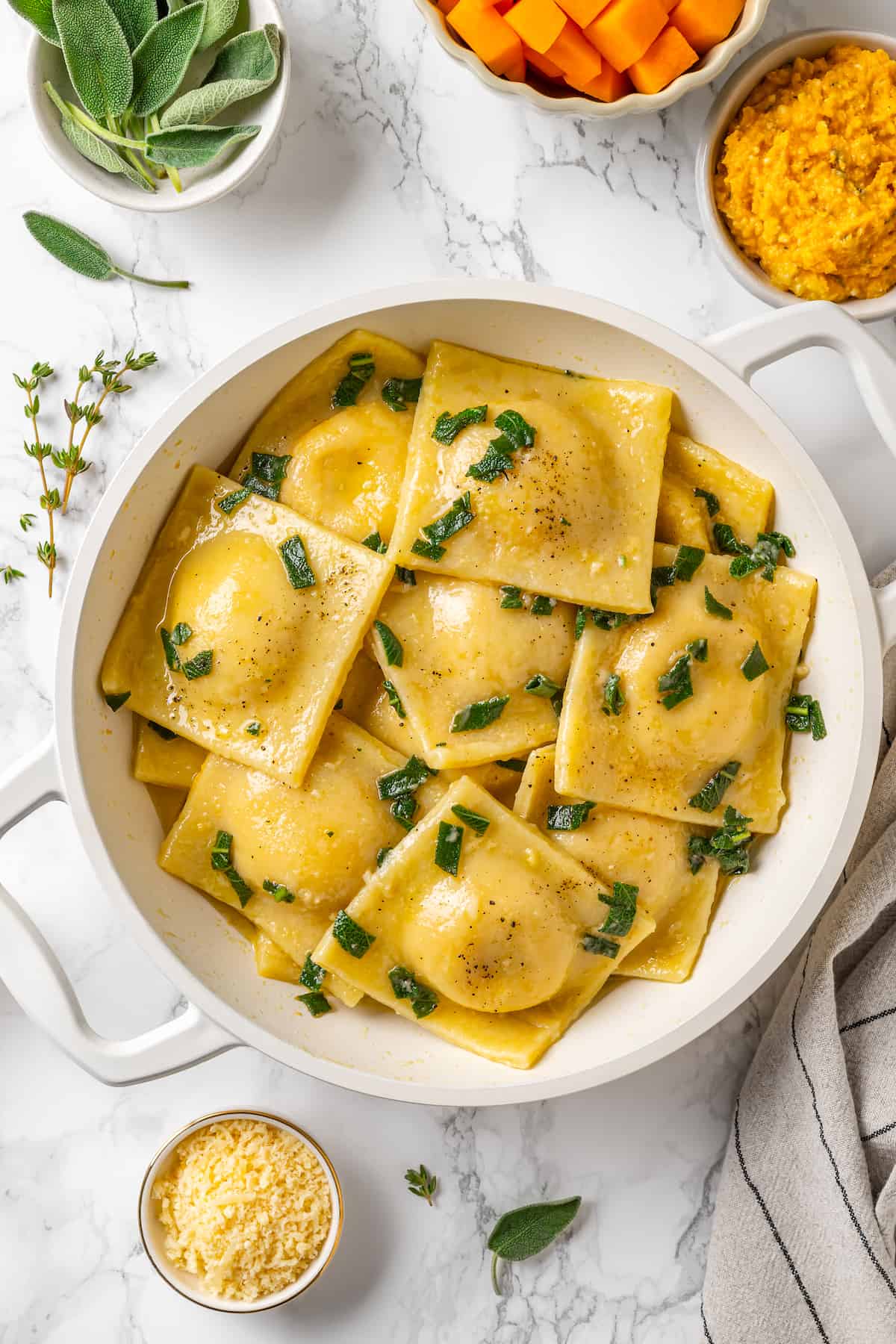 Butternut squash ravioli in pan with sage and brown butter sauce