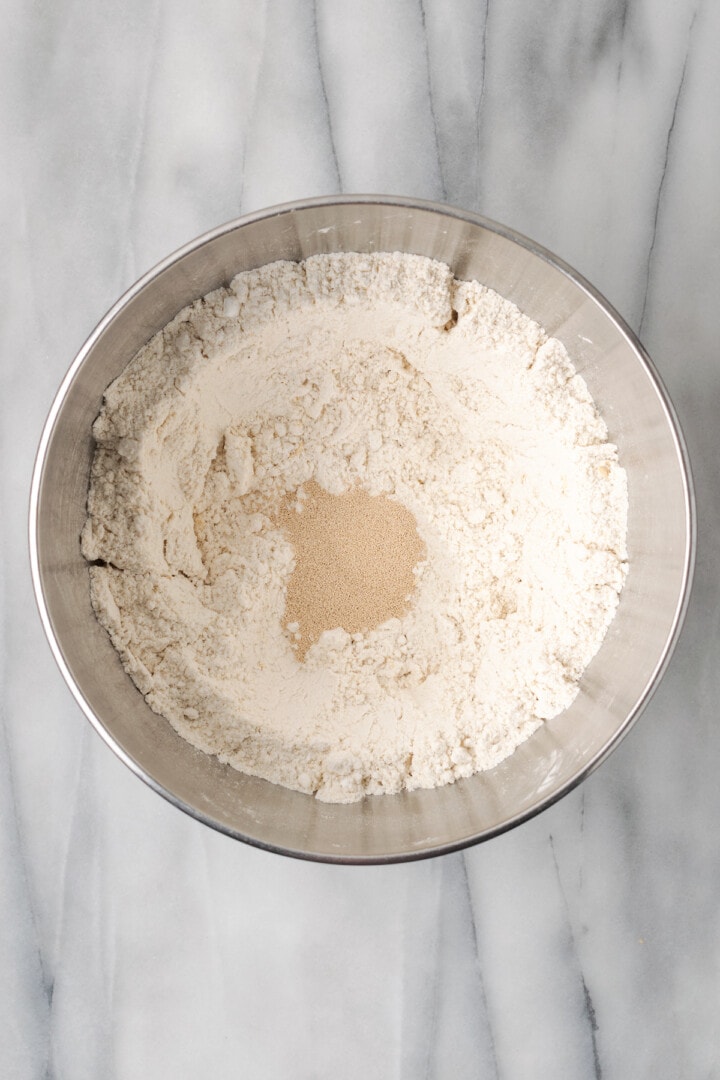 Overhead view of yeast added to dry ingredients for gluten-free sandwich bread