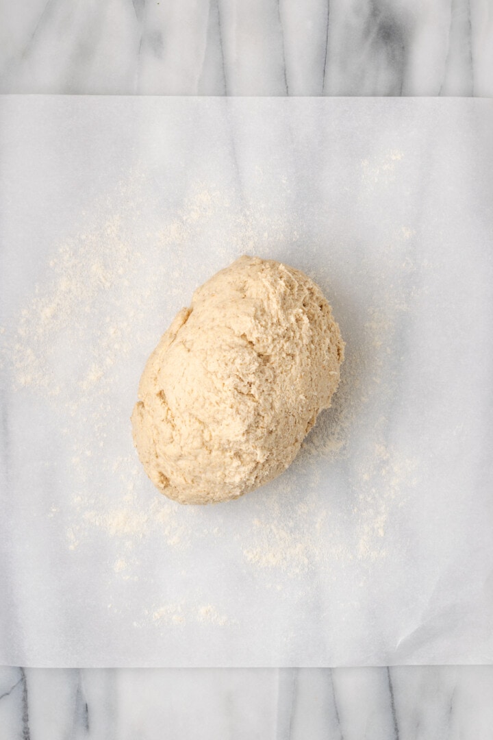 Overhead view of gluten-free dough turned out onto parchment paper