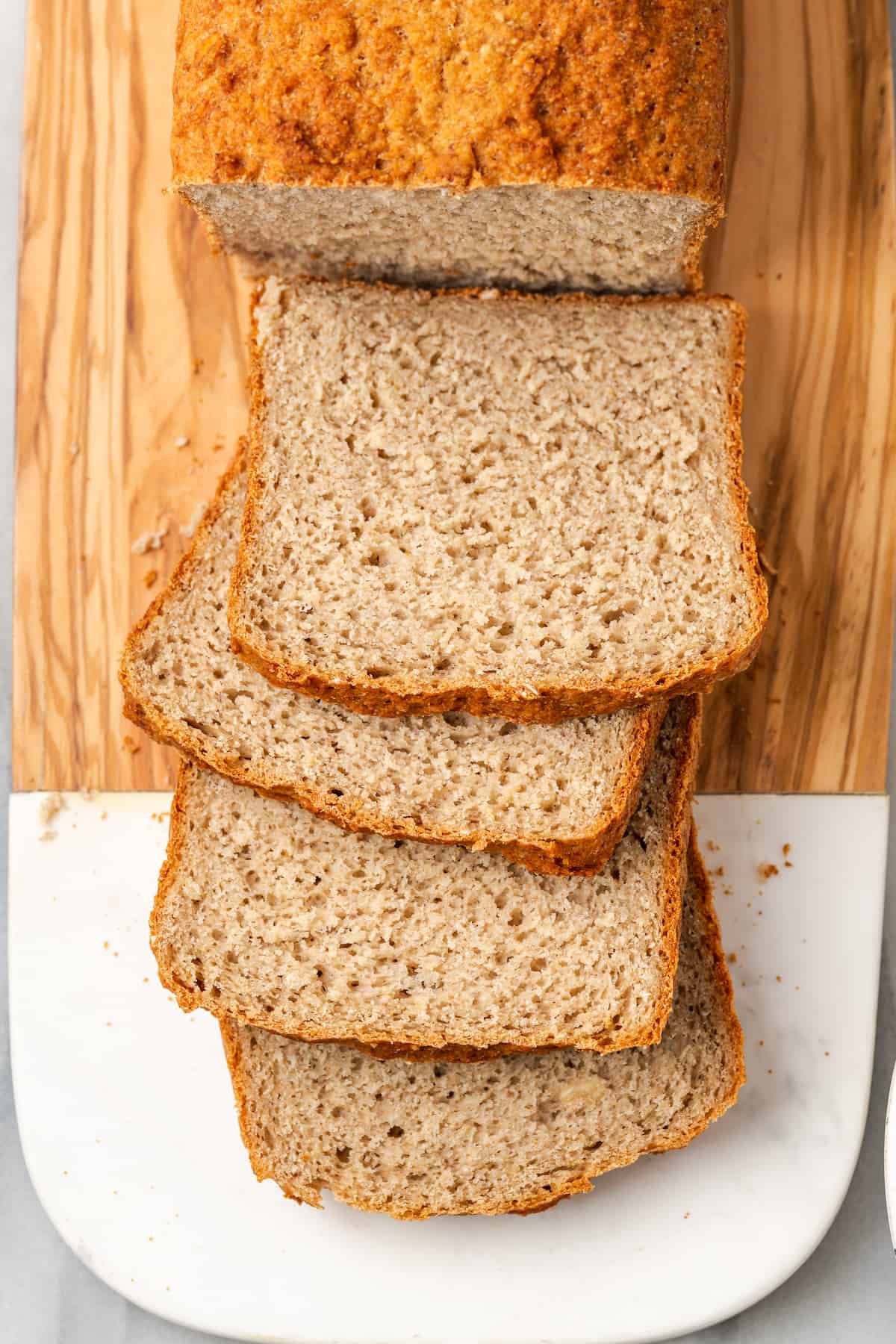 Overhead view of sliced gluten-free sandwich bread on cutting board