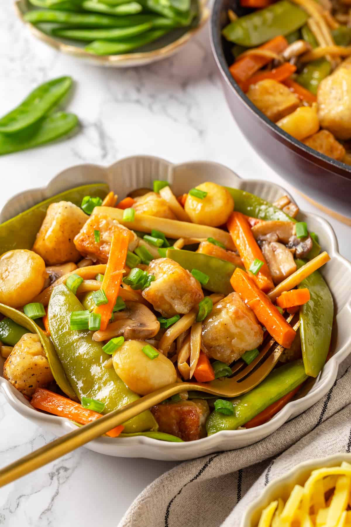 Vegan moo goo gai pan in bowl with fork