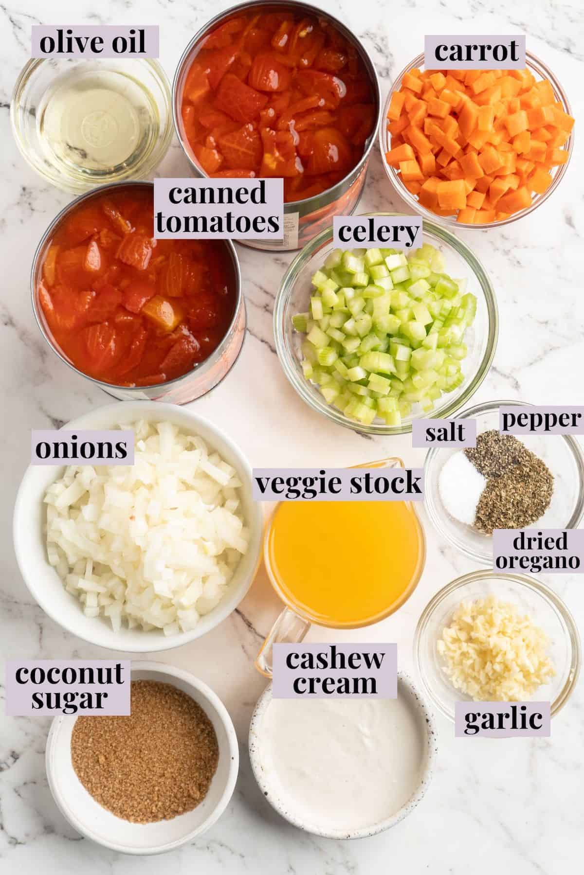 Overhead view of ingredients for creamy tomato soup with cheesy croutons with labels