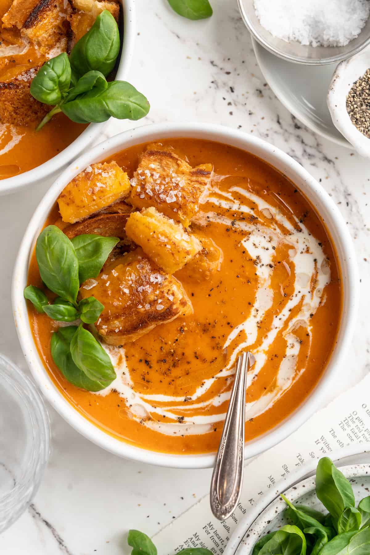 Overhead view of creamy tomato soup with cheesy croutons in bowl